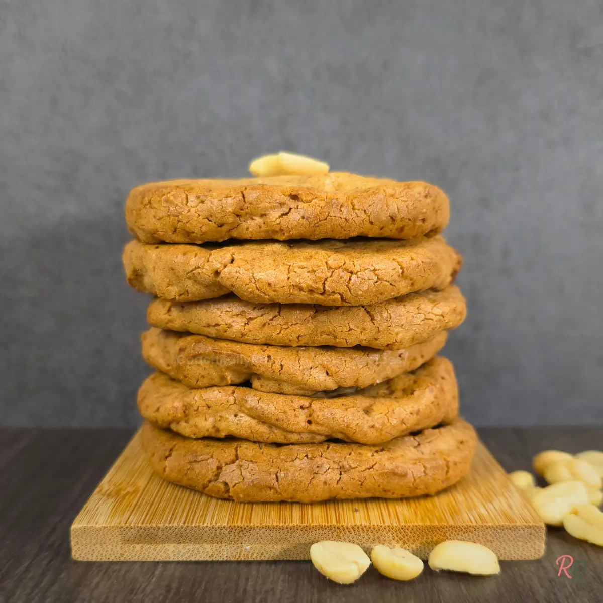 Low Carb Peanut Butter Cookies – Sugar Free and Gluten Free Golden brown keto peanut butter cookies stacked with peanuts on top.