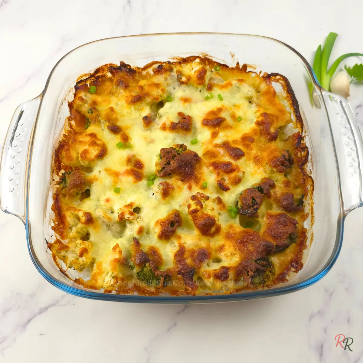 Golden Baked Keto Chicken Bacon Ranch Casserole Baked Keto Chicken Bacon Ranch Casserole with a golden cheesy topping in a glass dish.