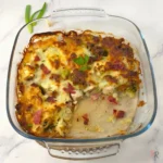 Keto Chicken Bacon Ranch Casserole with golden melted cheese, bacon, broccoli, and chicken in a glass baking dish.