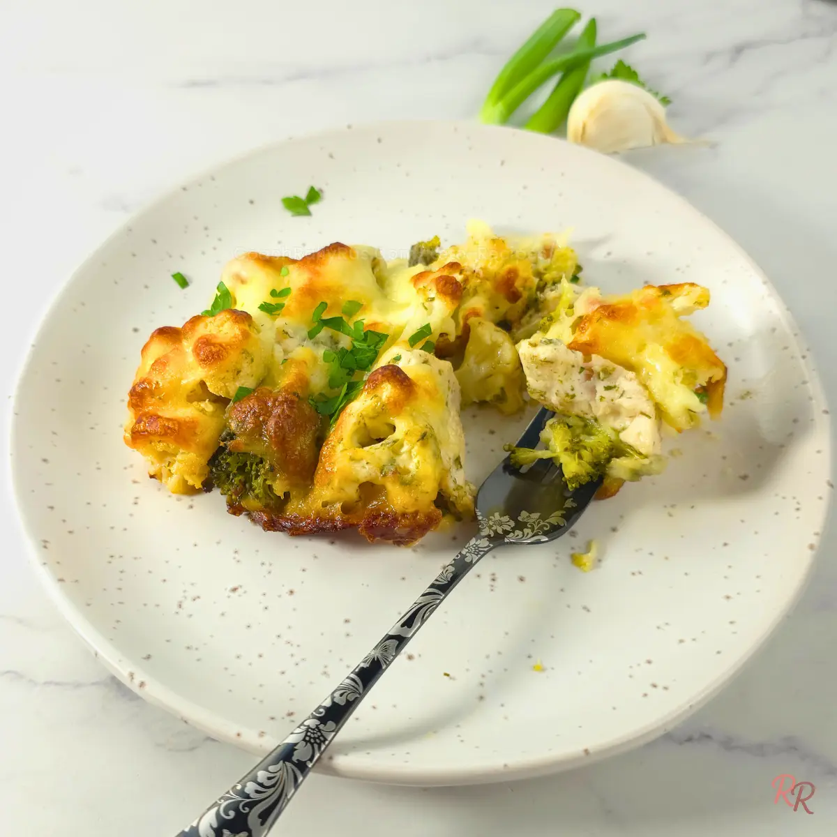 Low Carb Chicken Bacon Ranch Casserole with Cottage Cheese Keto chicken bacon ranch casserole portion on a white plate with melted cheese, broccoli, and chicken.