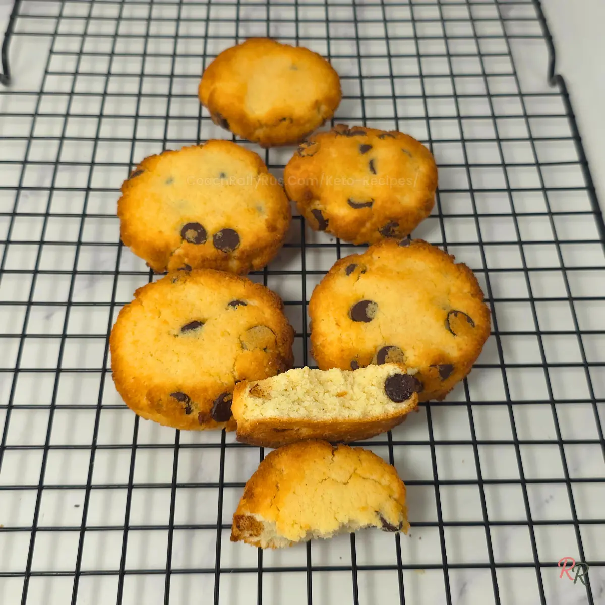 Freshly baked keto chocolate chip cookies on cooling rack Chewy keto chocolate chip cookies cooling on a wire rack
