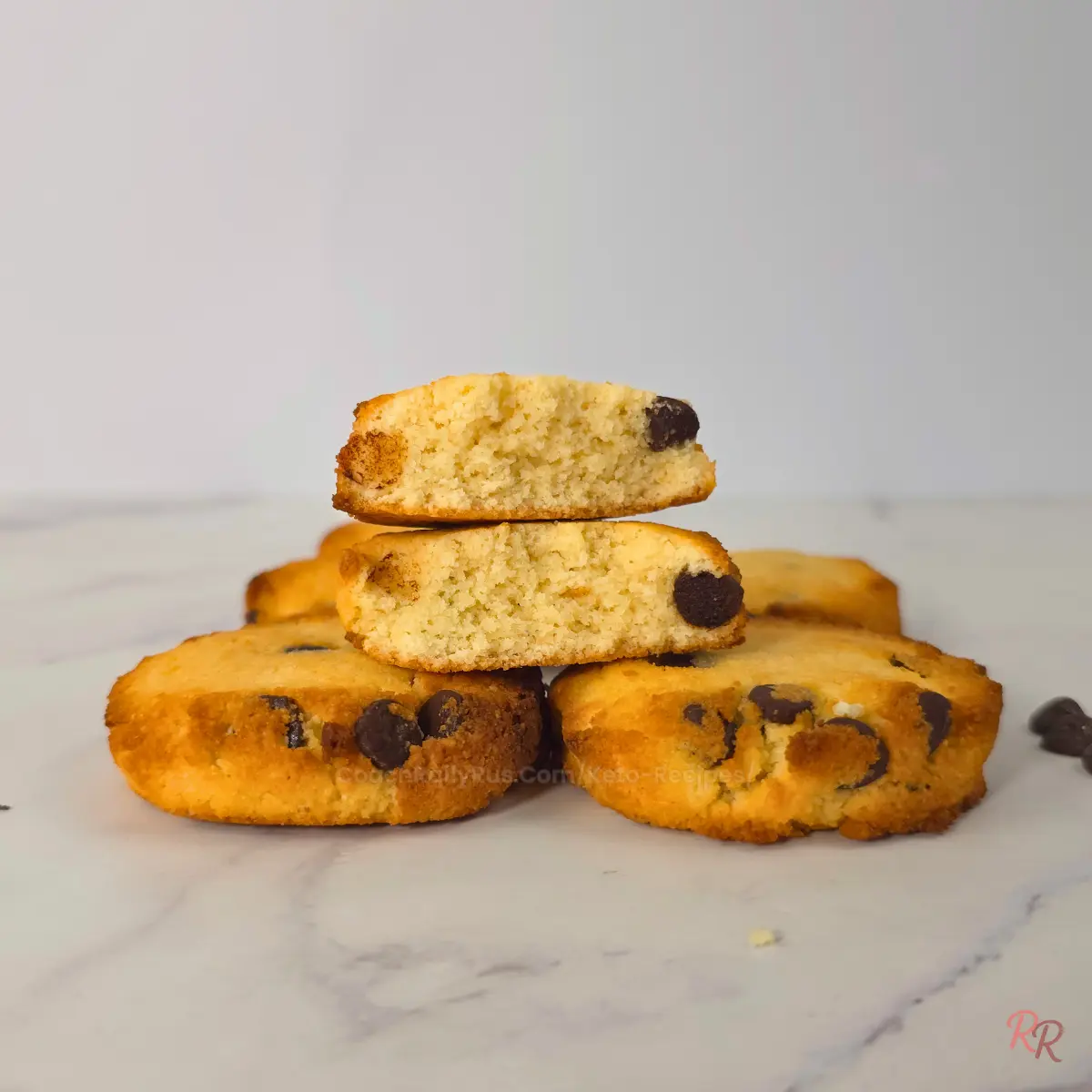 Almond flour keto cookies stacked with chocolate chips  Keto chocolate chip cookies stacked with two halves on top showing the inside texture