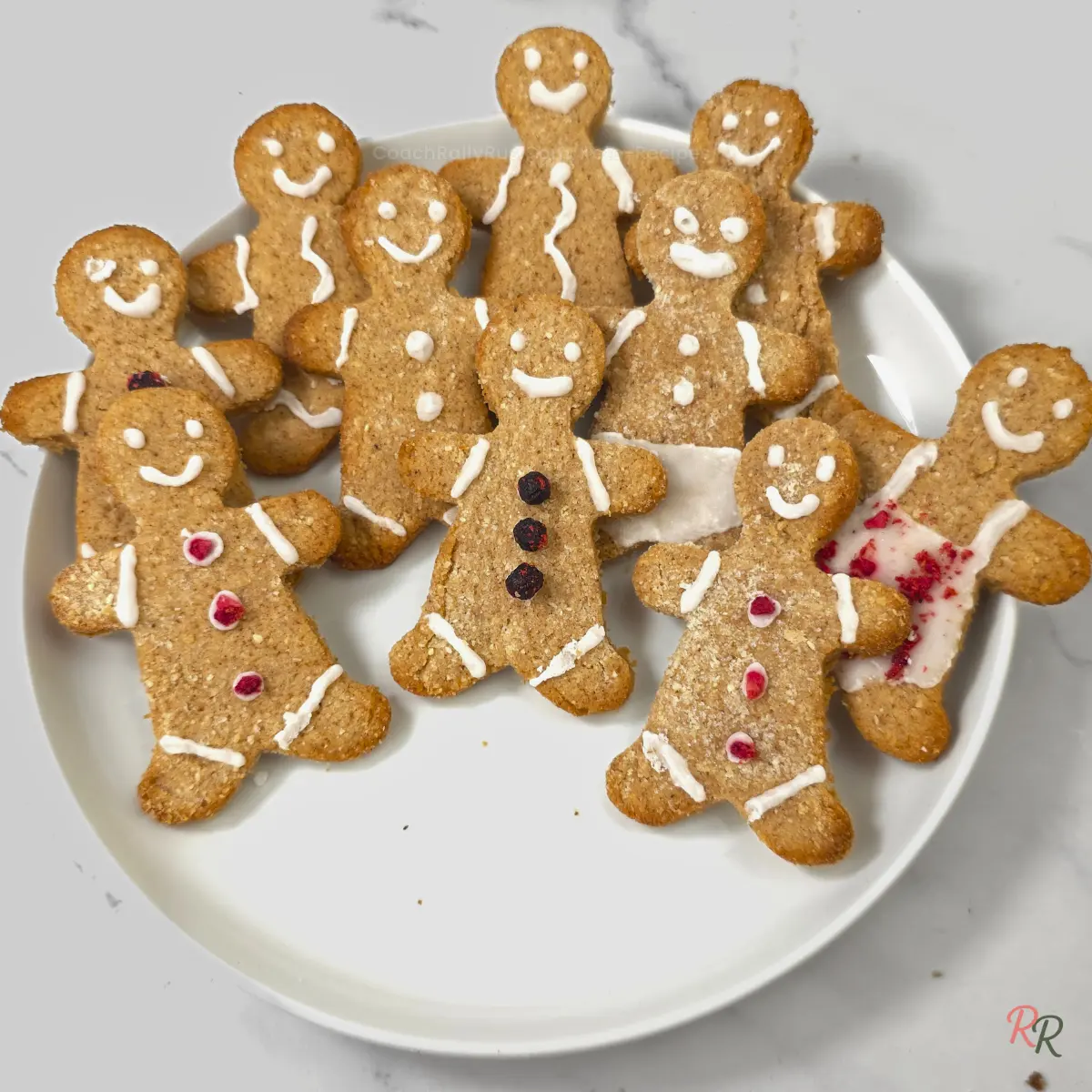 Zoomed view of decorated keto gingerbread men with icing and colored buttons