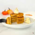 Fluffy keto pancakes with whipped cream and fall pumpkins