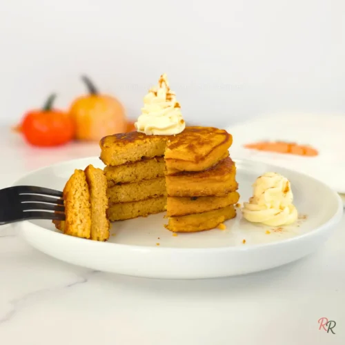 Fluffy keto pancakes with whipped cream and fall pumpkins