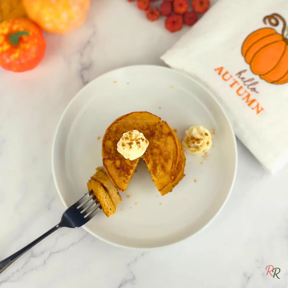 Overhead view of pumpkin cottage cheese pancakes with fork bite