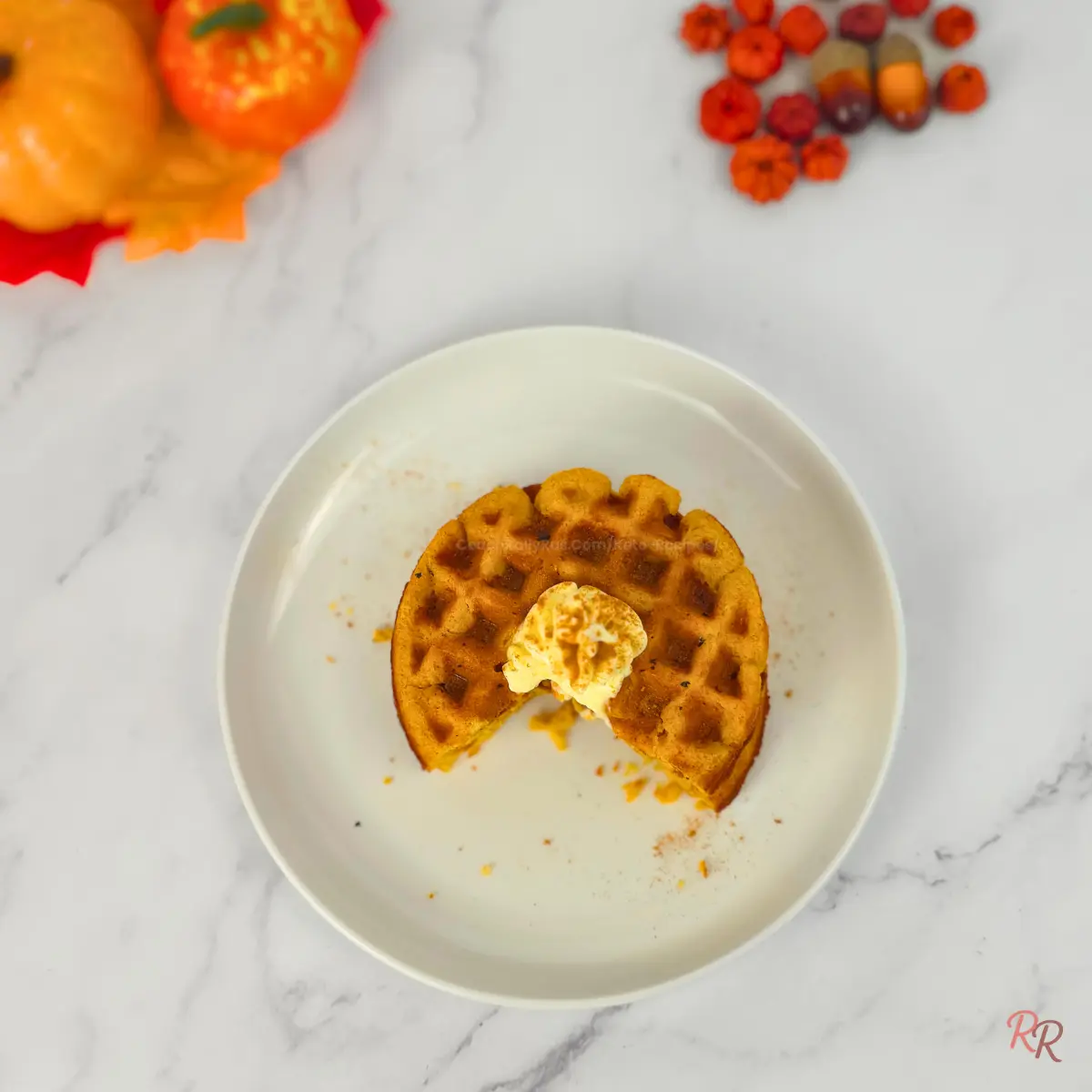 Overhead view of keto pumpkin cottage cheese waffle with whipped cream