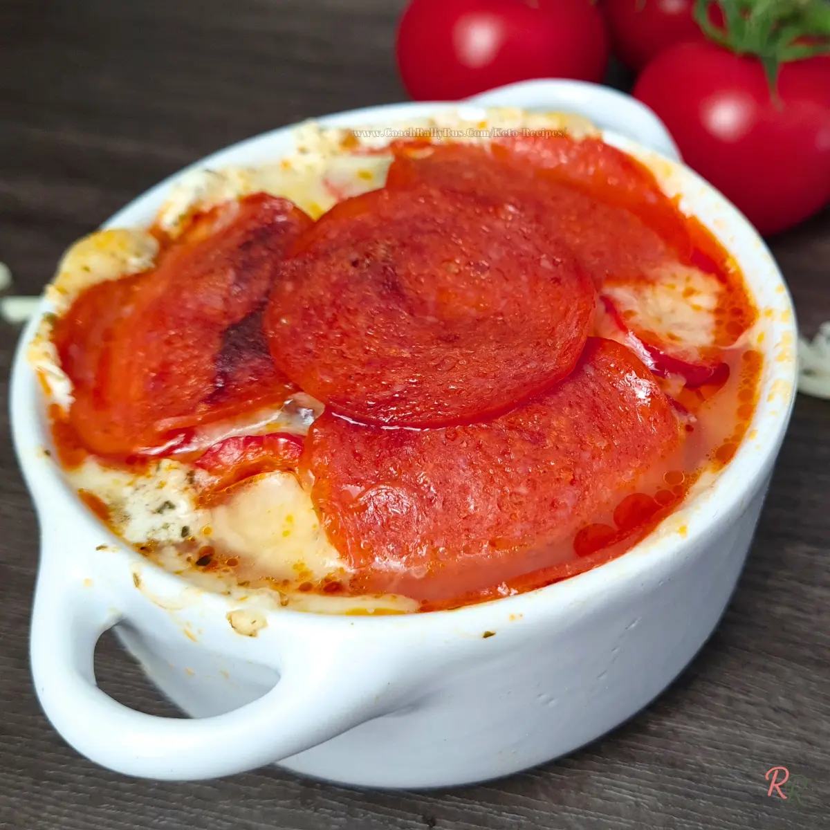 Keto cottage cheese pizza bowl with pepperoni and melted mozzarella in a white ramekin.