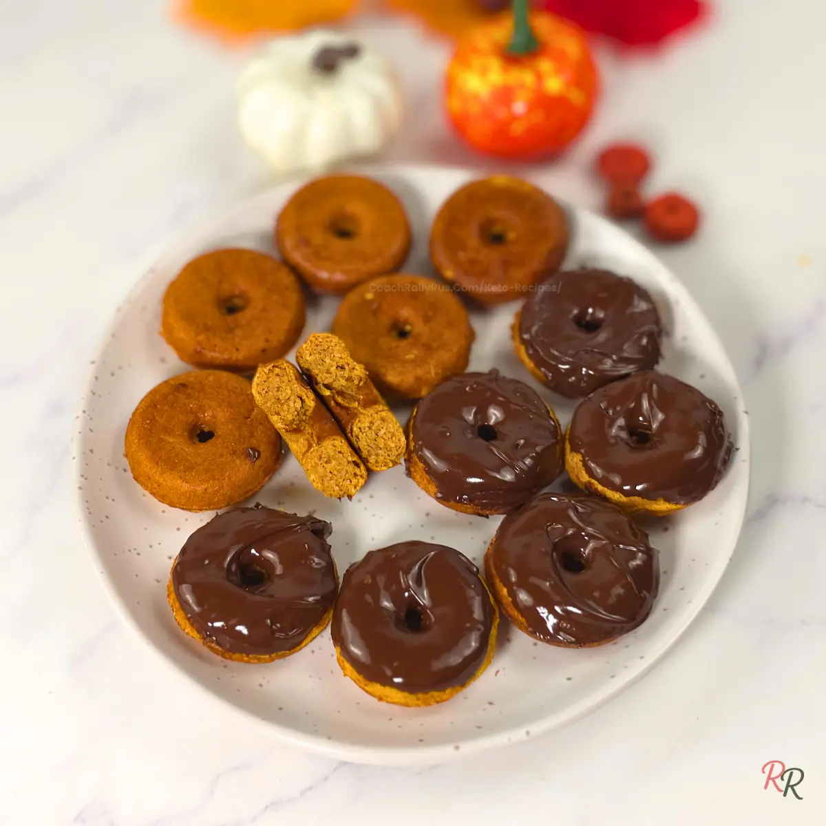 Keto Pumpkin Cottage Cheese Donuts with Coconut Flour Plate of keto pumpkin cottage cheese donuts with coconut flour, half plain and half chocolate glazed.
