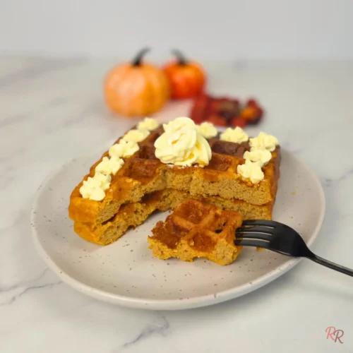 Pumpkin coconut flour waffle with fork and decorative butter swirl