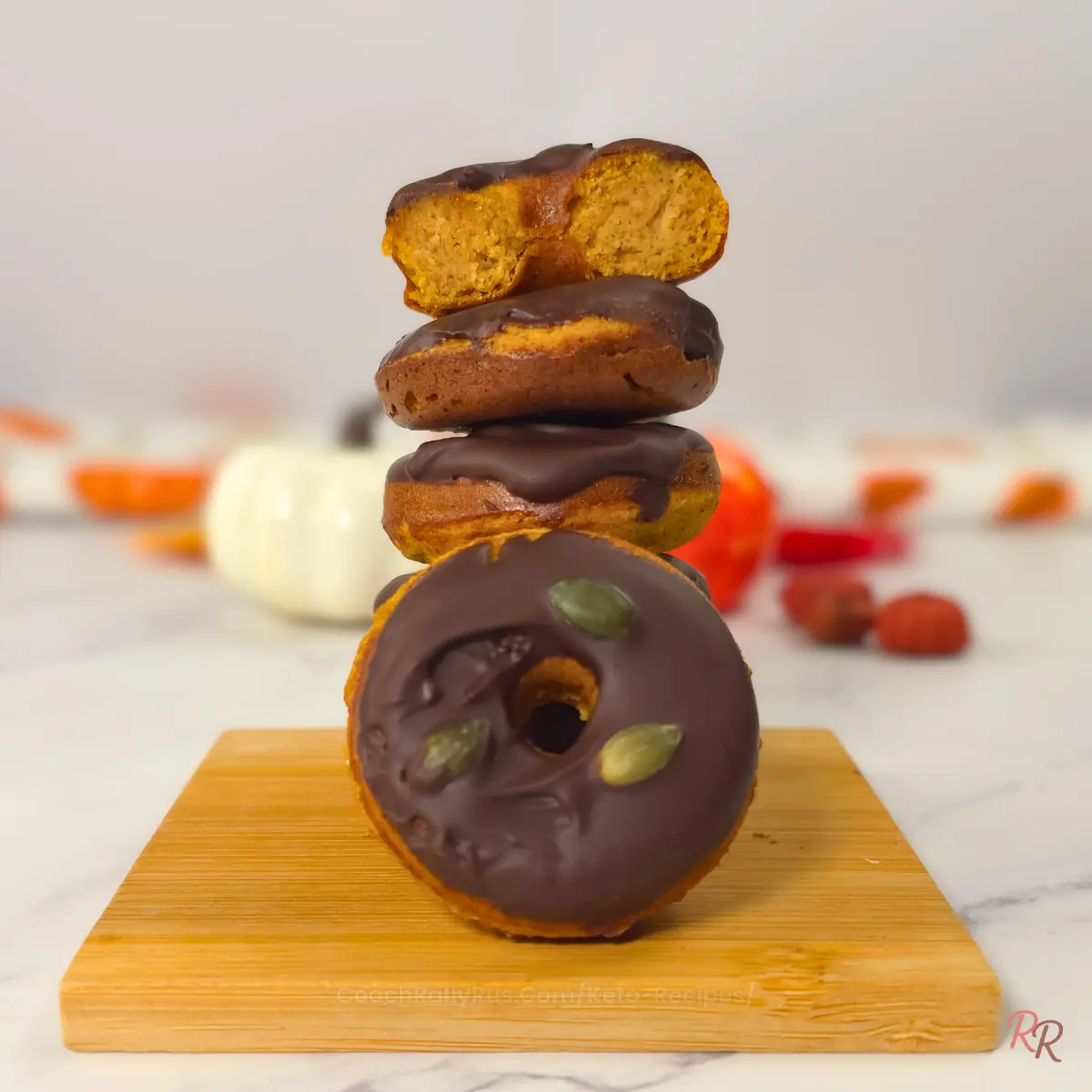 Gluten Free Pumpkin Donuts with Cottage Cheese and Almond Flour Stack of keto pumpkin cottage cheese donuts with almond flour, some coated in sugar free chocolate glaze