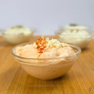 Bowl of whipped cottage cheese dip with feta and paprika, topped with crumbled feta
