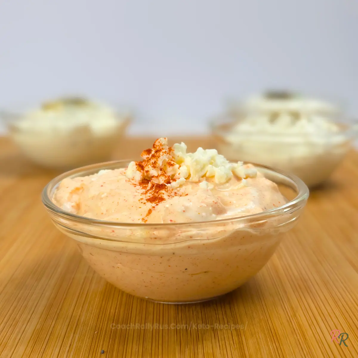 Bowl of whipped cottage cheese dip with feta and paprika, topped with crumbled feta
