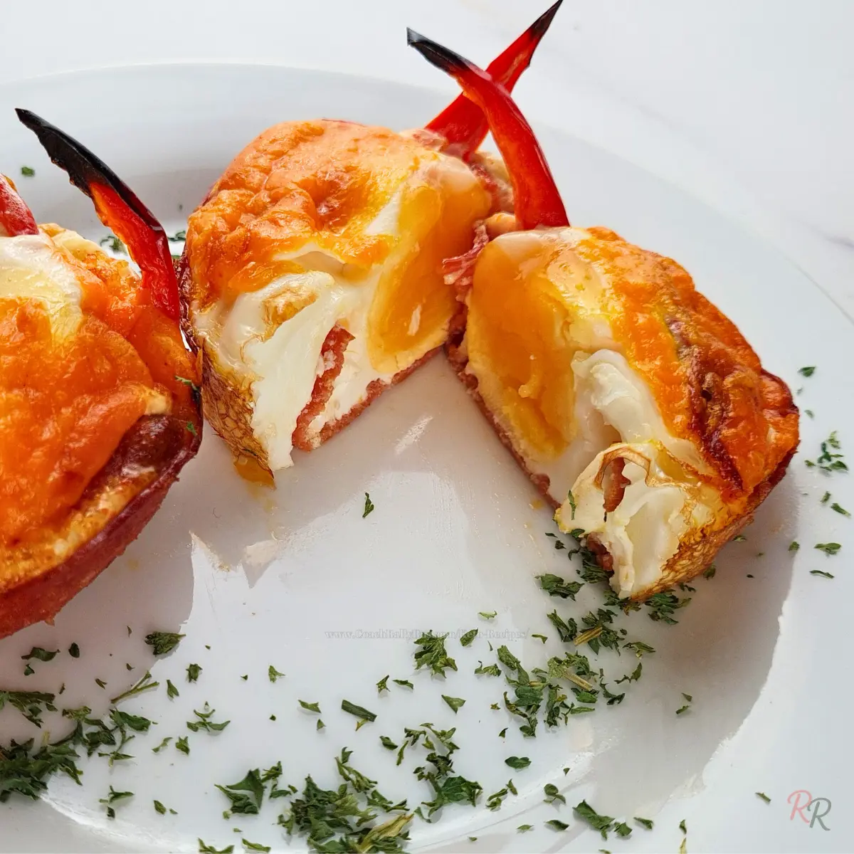 Cheesy Keto Egg Muffin with Red Pepper Single keto egg muffin with visible egg yolk and charred red pepper slice