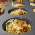 Keto cottage cheese egg muffin fresh out of the silicone muffin pan, golden brown and puffed.