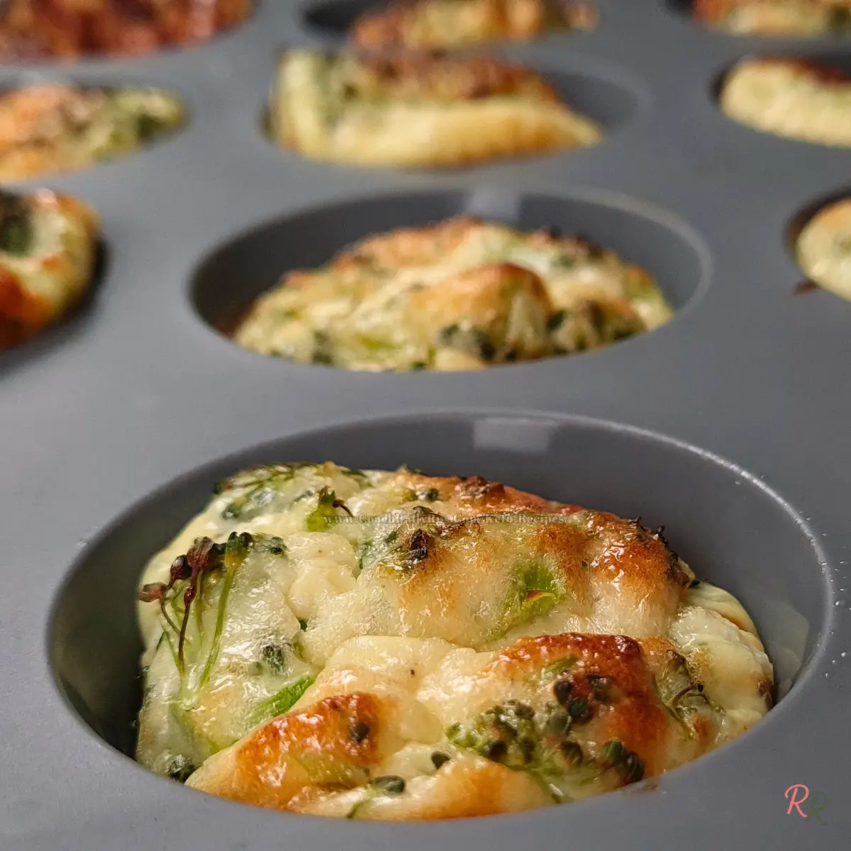 Keto cottage cheese egg muffin fresh out of the silicone muffin pan, golden brown and puffed.