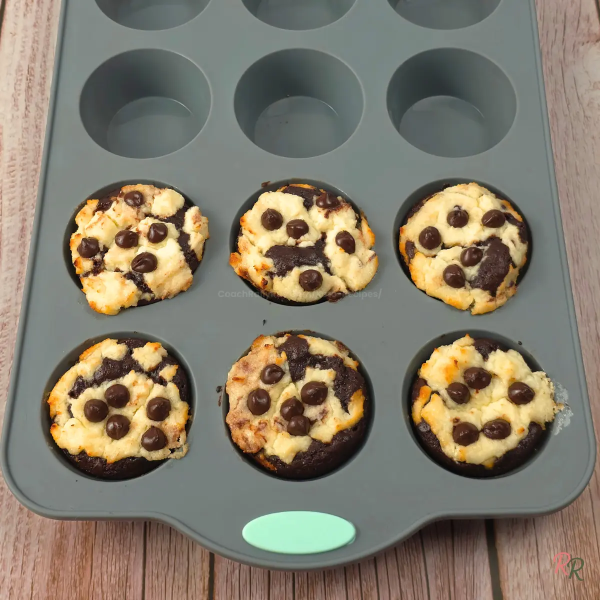 Six keto brookie muffins in a grey silicone muffin tin.