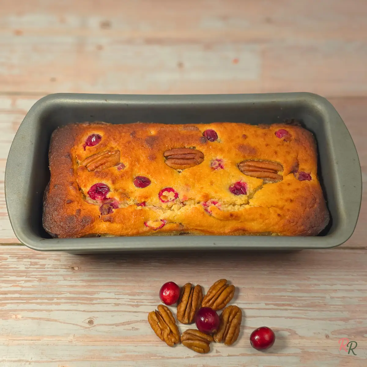 Keto cranberry bread with pecans and cottage cheese baked in a loaf tin before slicing