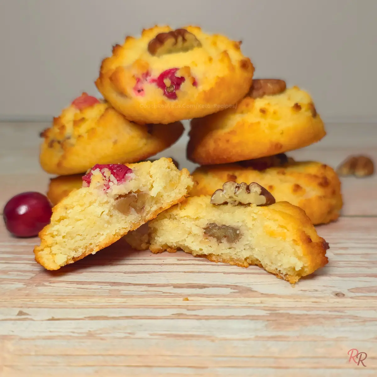 Soft keto cranberry cottage cheese cookie broken in half, showing a tender crumb with chopped pecans and cranberries inside