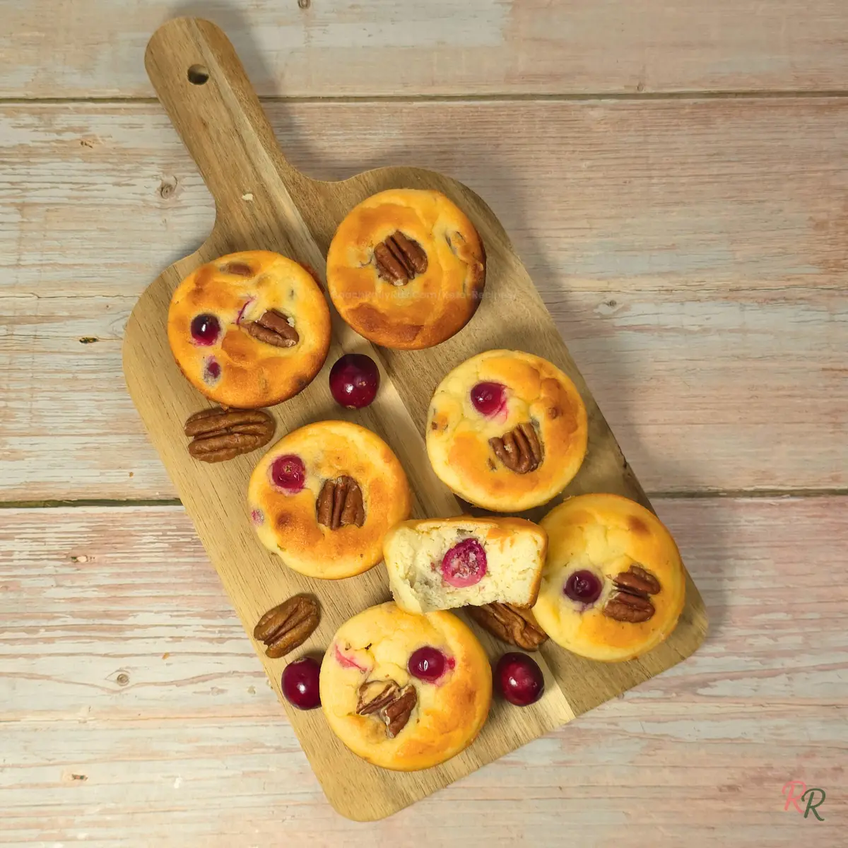 Bakery-Style Gluten Free Keto Cranberry Pecan Breakfast Muffins Keto cranberry pecan cottage cheese breakfast muffins arranged on a wooden board