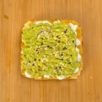 Crushed avocado cottage cheese toast on keto cottage cheese mug bread with everything bagel seasoning