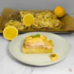 Lemon pepper chicken Alfredo on a cabbage steak with creamy cottage cheese sauce and lemon