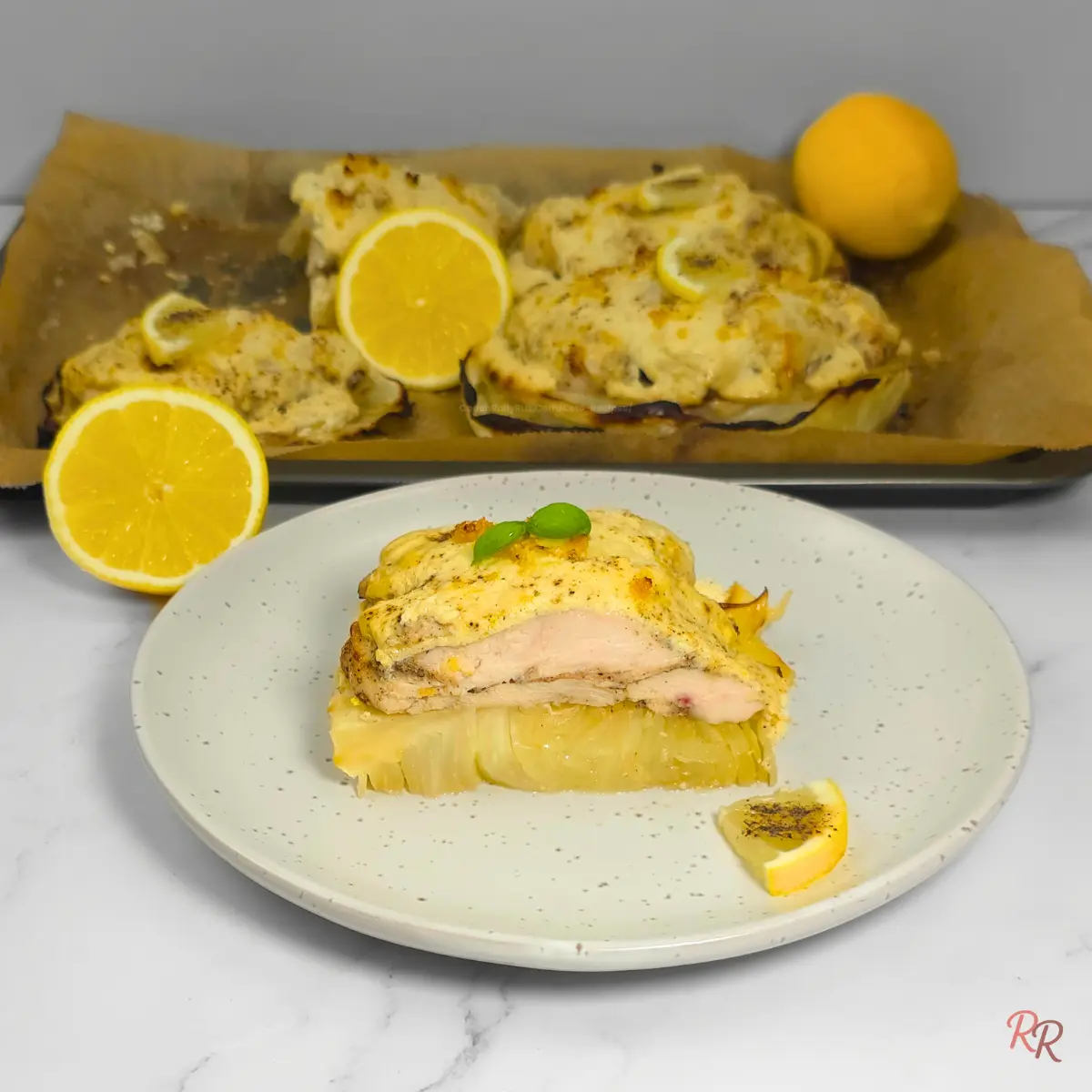 Lemon pepper chicken Alfredo on a cabbage steak with creamy cottage cheese sauce and lemon