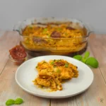 Marry me chicken cabbage casserole with cottage cheese sauce in a glass baking dish and plated serving