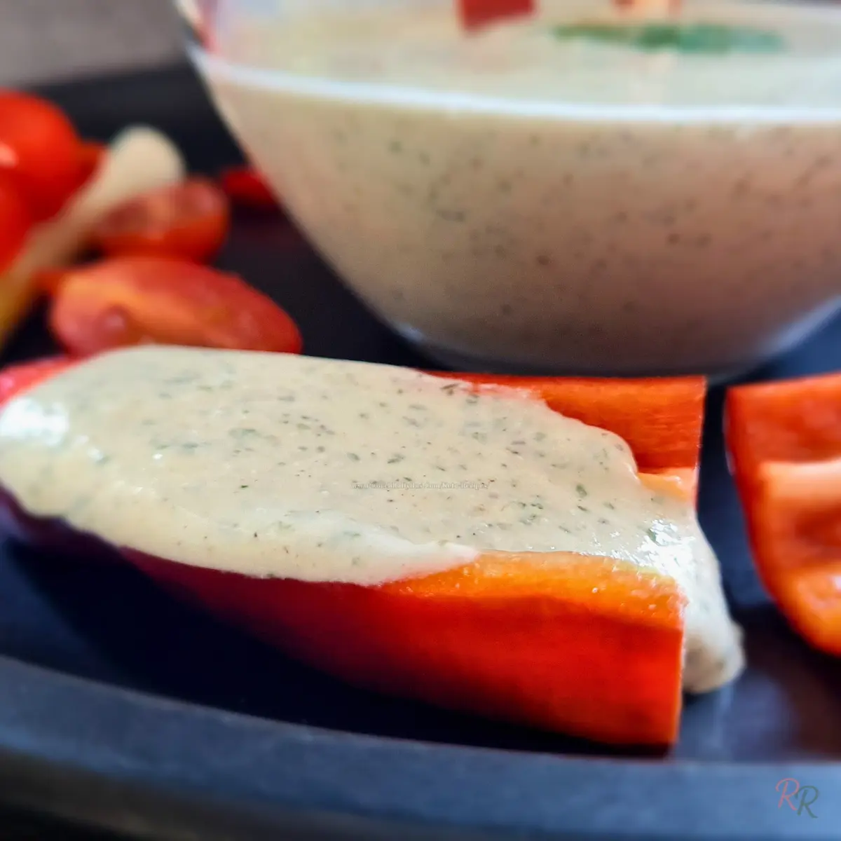 Keto Cottage Cheese Ranch Dip on Red Pepper Close-up of keto cottage cheese ranch dip spooned over a red pepper slice