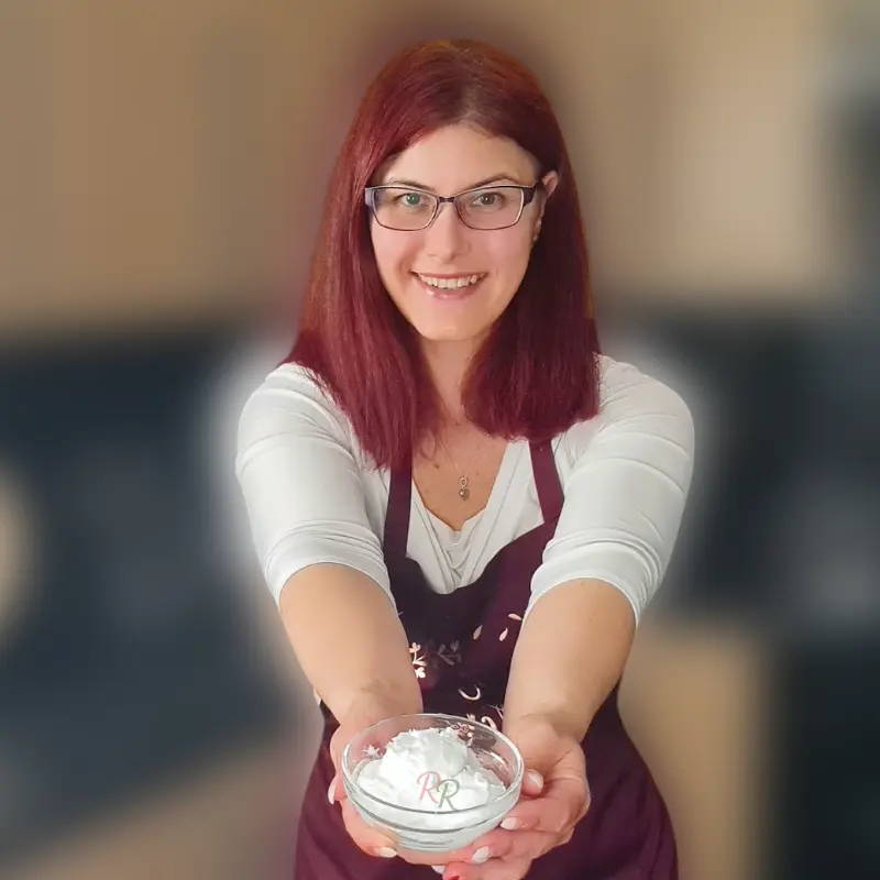 Rally Rus holding a bowl of food in her kitchen, real life keto recipe creator and guide